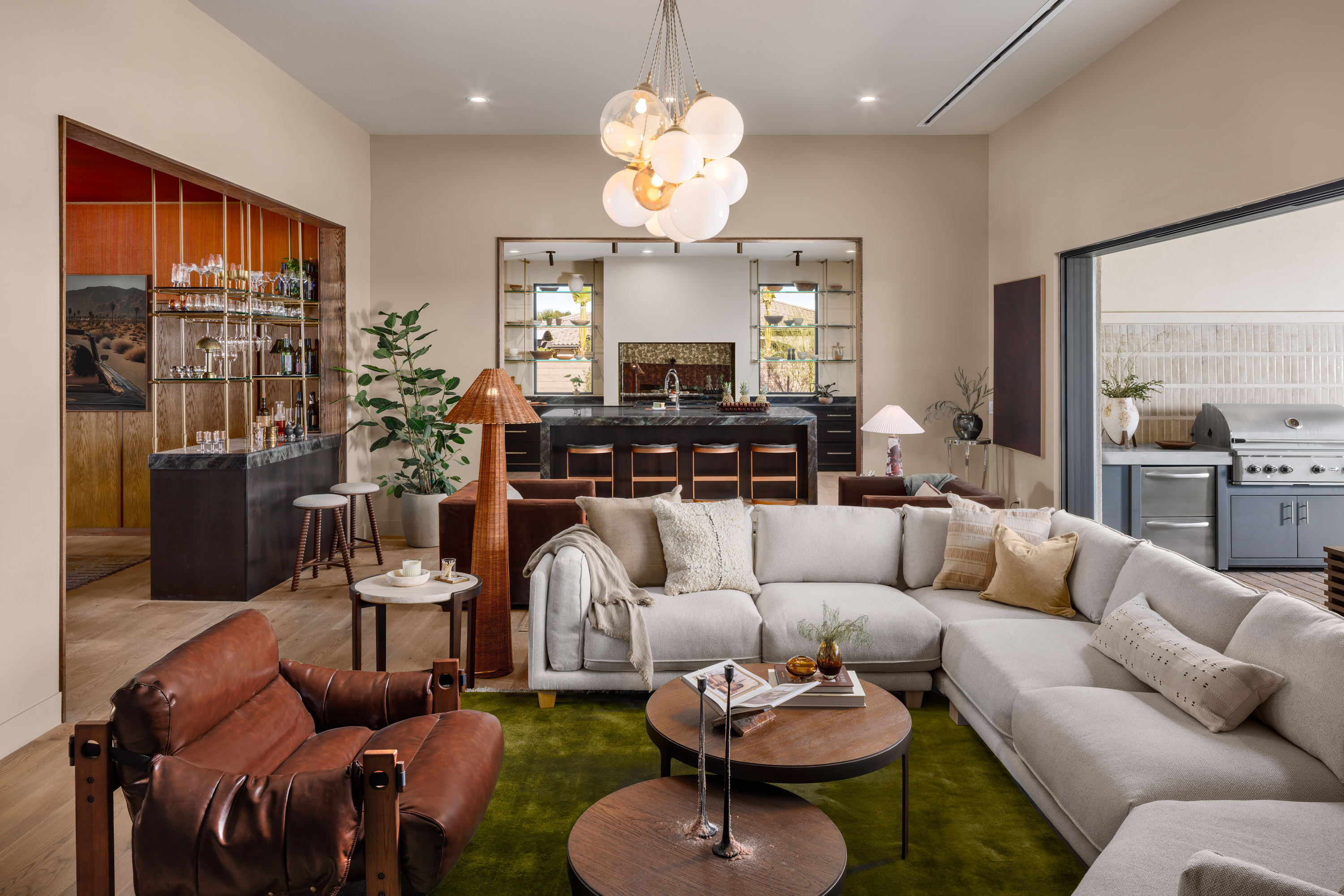 Living room with a large sectional and rich leather accent chairs